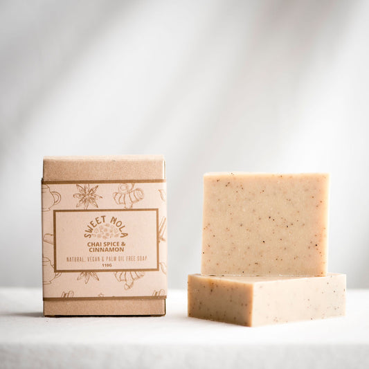 Chai spice and cinnamon bar soap. A soap box with brown label is on the left and the bar soap is on the right.