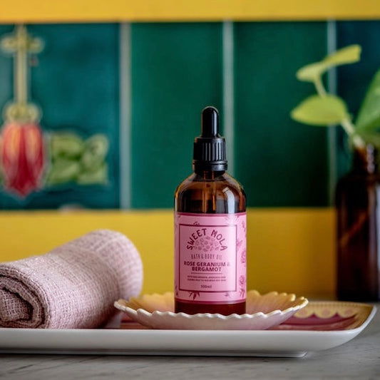 Rose geranium and bergamot bath and body oil. In a glass amber dropper bottle with pink label.