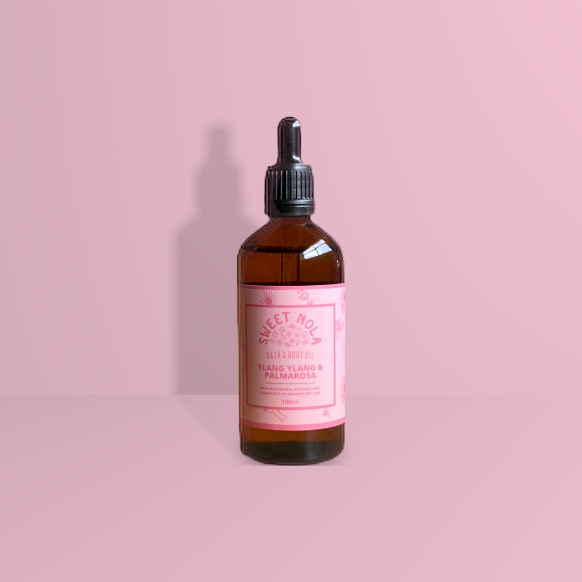 Ylang Ylang and palmarosa bath and body oil. In a 100ml glass amber dropper bottle with pink label.